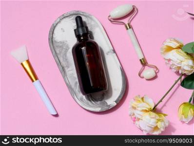 Brown glass bottle with a pipette, a green stone hand massager for cosmetic procedures on a pink background, top view
