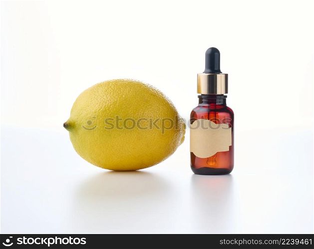 brown glass bottle with a pipette and an empty pasted paper label, lemon. Natural cosmetics on a white background