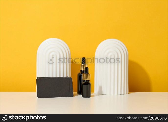 brown glass bottle with pipette stands on a white table. Cosmetics SPA branding. Packaging for gel, serum, advertising and product promotion, mock up