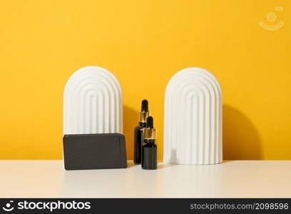 brown glass bottle with pipette stands on a white table. Cosmetics SPA branding. Packaging for gel, serum, advertising and product promotion, mock up