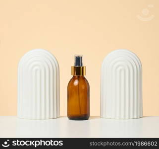 brown glass bottle with spray on white background. Cosmetics SPA branding mockup
