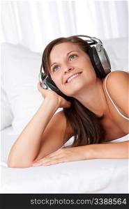 Brown hair smiling woman with headphones listening to music