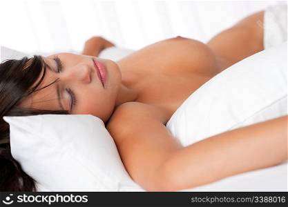 Brown hair woman sleeping in white bed, focus on left eye, shallow DOF