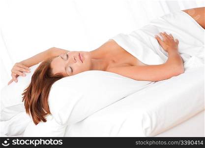 Brown hair woman sleeping on white bed, shallow DOF