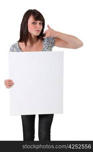 Brown-haired girl holding white panel for message