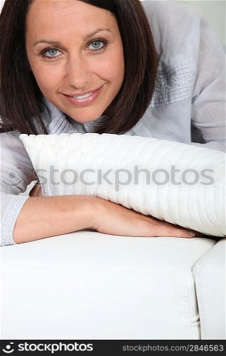Brown-haired woman laid on a sofa