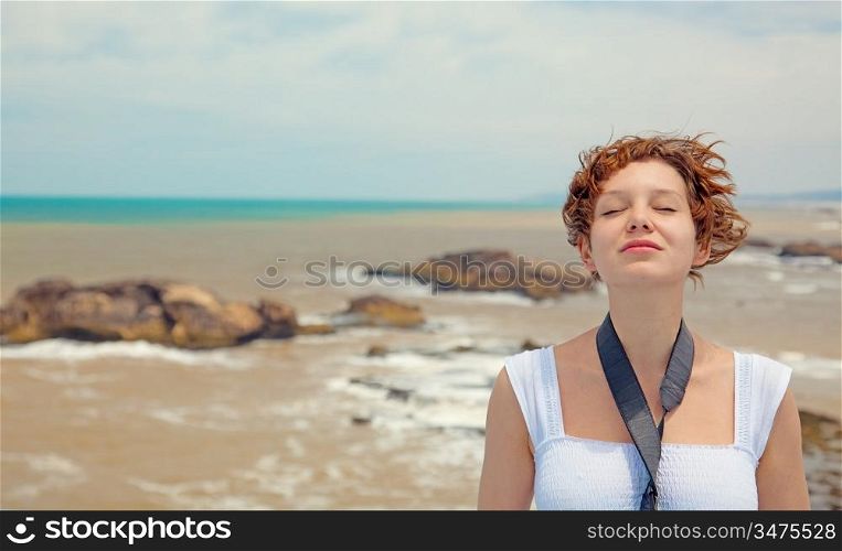 brown-haired young woman, over beautiful sea landscape photo