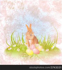 brown hare or rabbit sitting in the grass with easter eggs and daisies grunge