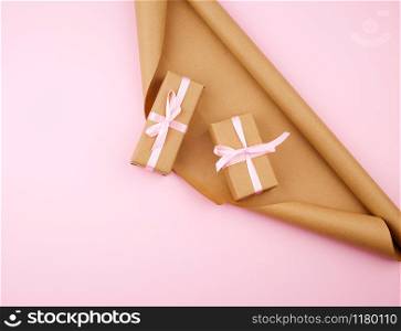 brown kraft paper, packed gift boxes and tied with a pink ribbon, set of items for making gifts. Package design, copy space
