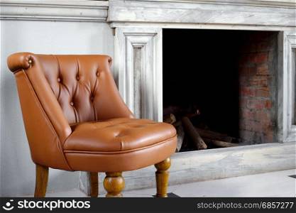 brown leather armchair in front of fireplace