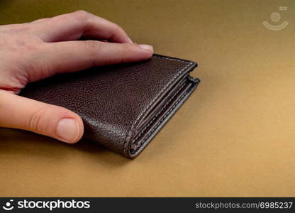 Brown leather wallet in hand saving and finance concept