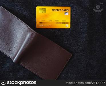 Brown leather wallet on jeans background.