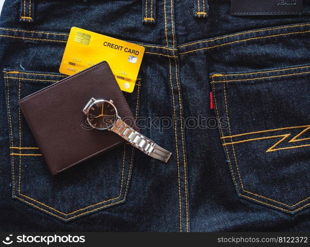 Brown leather wallet on jeans background.