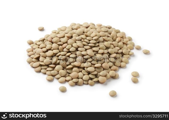 Brown lentils scattered on white background