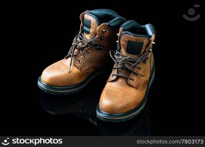 brown men&rsquo;s boots on black background