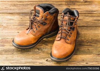 brown men&rsquo;s boots on wooden background