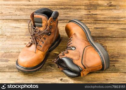 brown men&rsquo;s boots on wooden background
