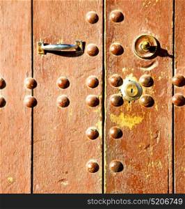 brown morocco in africa the old wood facade home and rusty safe padlock