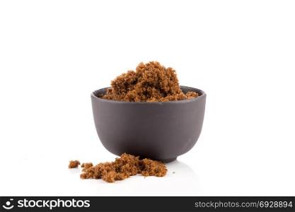 brown muscovado sugar in bowl isolated on white background