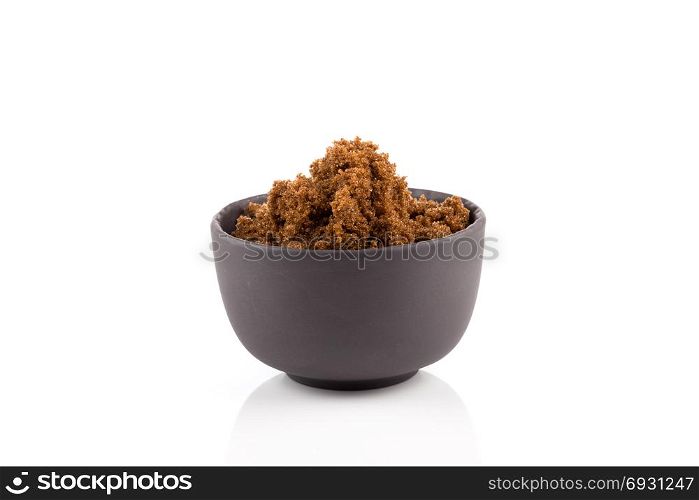 brown muscovado sugar in bowl isolated on white background