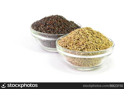 Brown Mustard and cumin seeds in glass bowl on white background