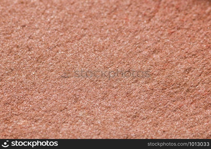 Brown nude texture of the blush for the face closeup. Selective focus background.