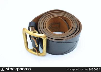 Brown officer belt braided in a roll as a roll with a metal metal plate.