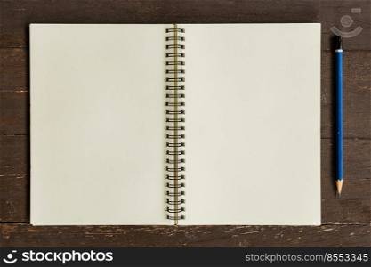 Brown open book with pencil on wood table