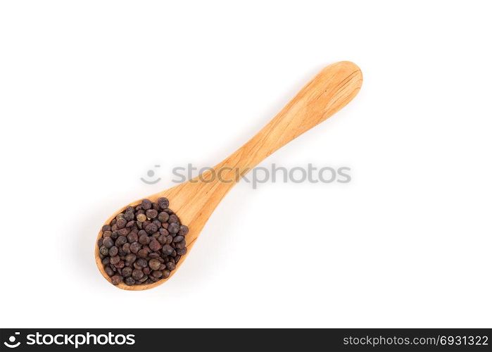 Brown organic lentils in wooden spoon isolated on white background