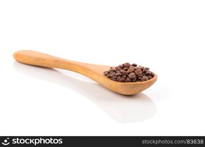 Brown organic lentils in wooden spoon isolated on white background