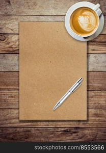 brown paper and coffee on wood background with pen