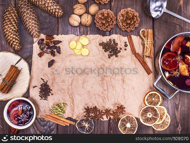 brown paper and ingredients for making mulled wine, top view, empty space