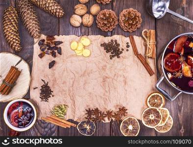 brown paper and ingredients for making mulled wine, top view, empty space