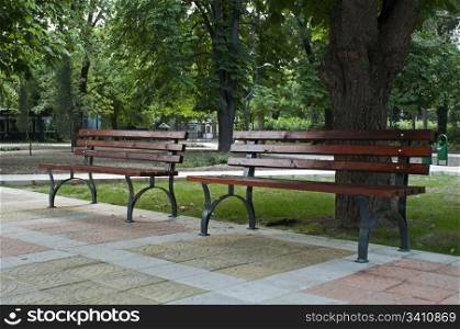 Brown park benches. Horizontal image