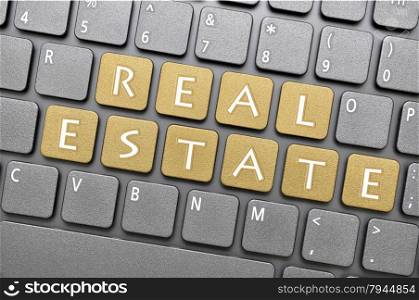 Brown real estate key on keyboard
