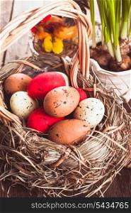 Brown, red and yellow eggs in basket, Easter decor