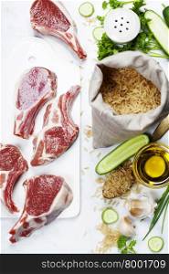 Brown rice and Raw lamb chops - cooking or healthy eating concept