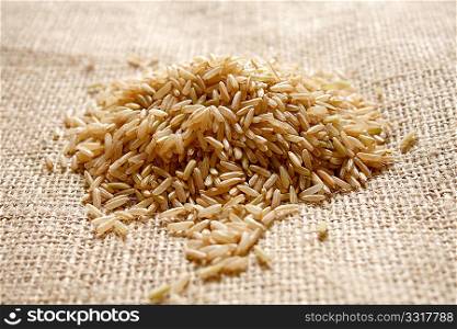 Brown rice on a textile background
