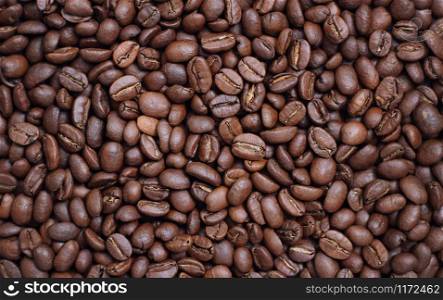 Brown roasted aromatic coffee beans as background. Roasted aromatic coffee beans as background