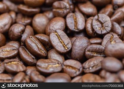 Brown roasted coffee beans. Closeup shot of coffee beans. Coffee beans can be used as a background.