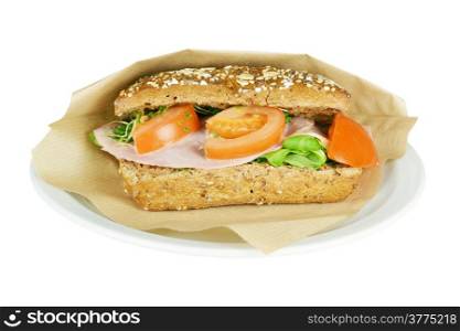 Brown sandwich with ham, tomato, lettuce, mustard sauce on a white background.