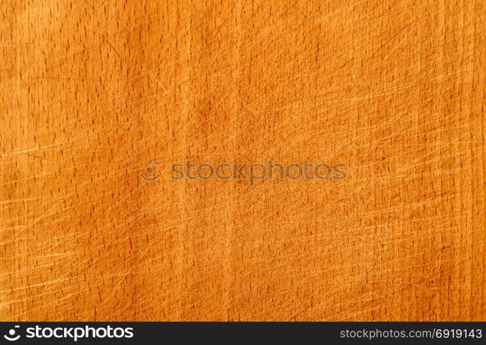 Brown scratched wooden cutting board. Wood texture