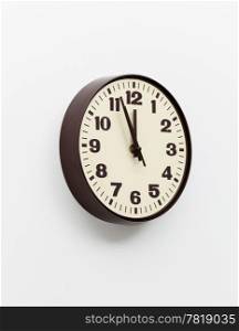 Brown simple plastic wall clock on the wall of office and concept of running out of time