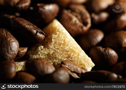 Brown sugar cube and coffee beans background. Natural morning sunlight.