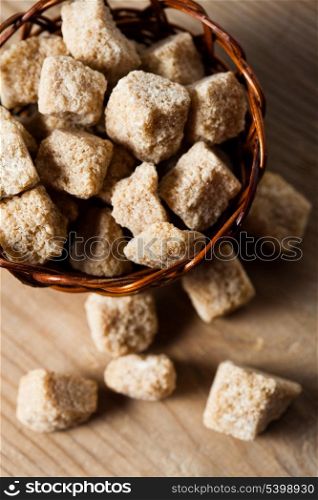 Brown sugar, natural cubes closeup in basket