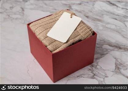 brown sweater in the red gift box