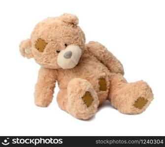 Brown teddy bear on a white background. Toy bent over