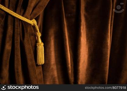 Brown theatre curtain and yellow tassels