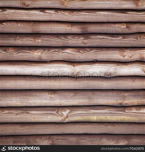 brown varnished planks on outside of barn wall on farm