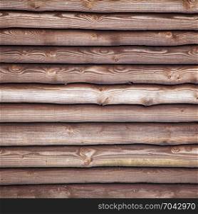 brown varnished planks on outside of barn wall on farm